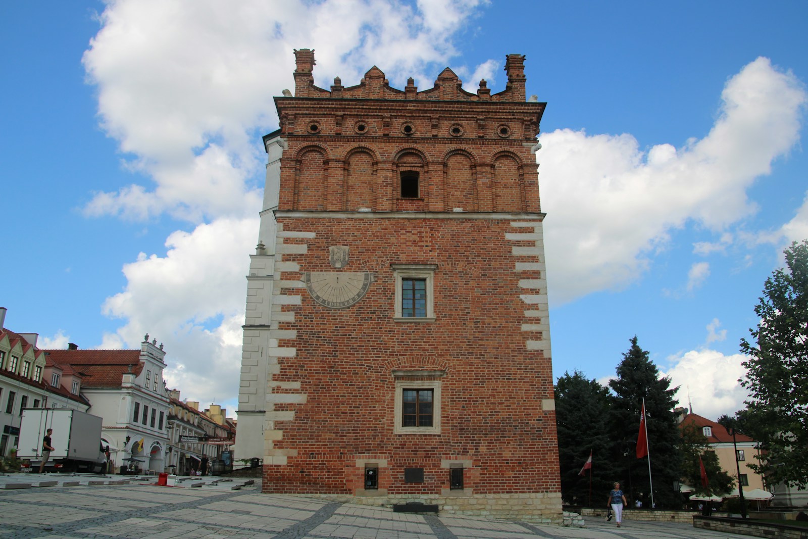 A tall brick tower with a clock on it's side